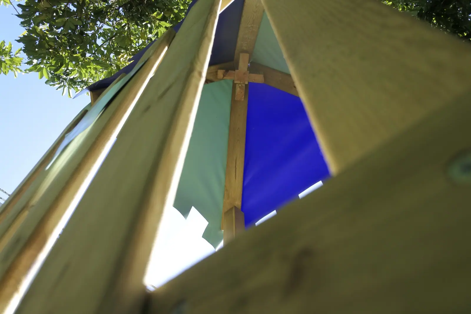 Looking up at the green and blue canopy of Zazoo's wooden play tower